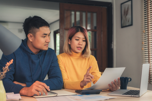 Man and women filing taxes online